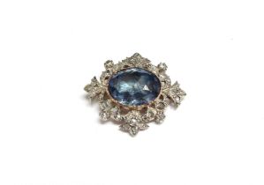 A sapphire and diamond brooch, the central oval sapphire 17mm x 15mm framed by old cut diamonds in