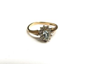 A 9ct gold aquamarine and diamond cluster ring. Size M, 1.8g