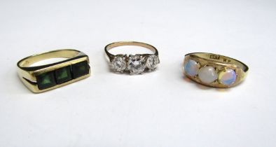 Two 9ct gold rings including three stone example and a 14ct gold ring set with three green stones,