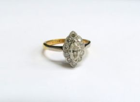 An 18ct gold platinum set diamond ring, the central marquise cut diamond framed by ten round cut
