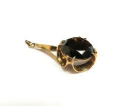 A 9ct gold pendant set with a large circular smoky quartz, 4.5cm long, 6.5g