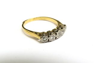 An 18ct gold ring set with five diamonds in illusion setting, cut. Size W, 4.3g