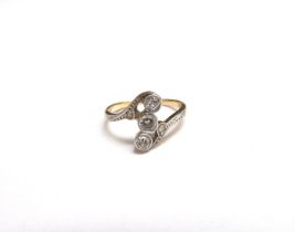 A gold ring with three North-South set diamonds in diamond set swirl shoulders, unmarked. Size G,