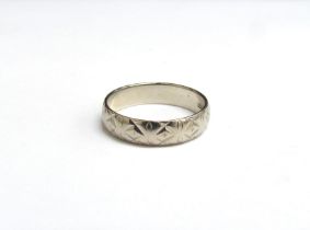 A 9ct white gold band with engraved detail, circa 1970's. Size O/P, 2.6g