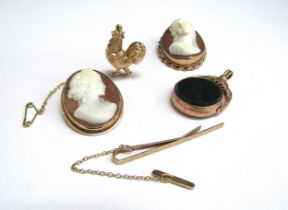 Two cameo brooches in 9ct gold frames a 9ct gold tie clip, 9ct gold cockerel charm and a 9ct gold
