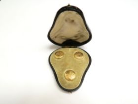 A set of three 15ct gold studs with engraved decoration, in fitted case, 4g