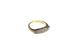 A gold ring set with five graduated stones in platinum mount, stamped 18ct. Size L/M, 2.7g