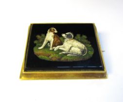 A 19th Century micro mosaic depicting two spaniels set within a rectangular black onyx panel, gilt