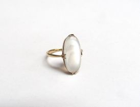 A gold ring with an oval cabochon moonstone, unmarked. Size K, 2g
