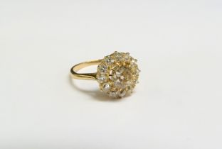 A diamond cluster ring, the central coloured diamond framed by twelve old cut white diamonds, 1.50ct