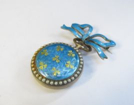 An enamel and pearl set fob watch with blue enamel bow brooch, some damage