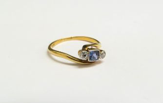 An 18ct gold platinum set sapphire and diamond crossover ring. Size N, 2.1g