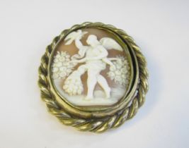 An oval carved shell cameo brooch depicting man with a bow and bird of prey
