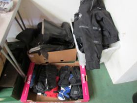 A quantity of motorcycling clothes including jackets, boots and gloves.