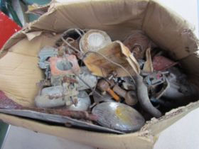 A box containing a quantity of assorted vintage car parts including carburettors, lamps, leases