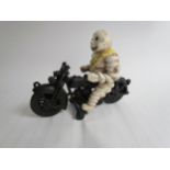 A reproduction cast Michelin Man riding a motorcycle - missing handle bars