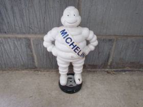 A reproduction cast Michelin Man standing on a wheel, 40cm tall