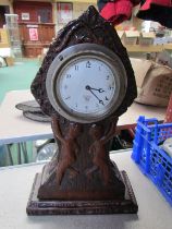 A Smiths dash clock mouted in carved wooden surround