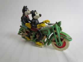 A cast reproduction figurine of Mickey and Mini Mouse riding a motorcycle