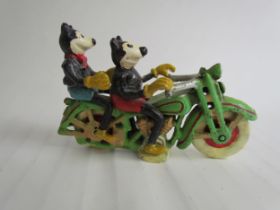 A cast reproduction figurine of Mickey and Mini Mouse riding a motorcycle