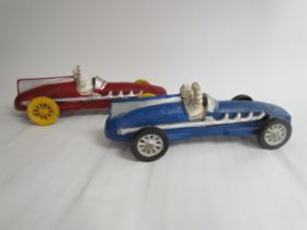 Two cast reproduction Michelin Men in vintage race cars