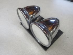 A pair of mounted chromed mirrors