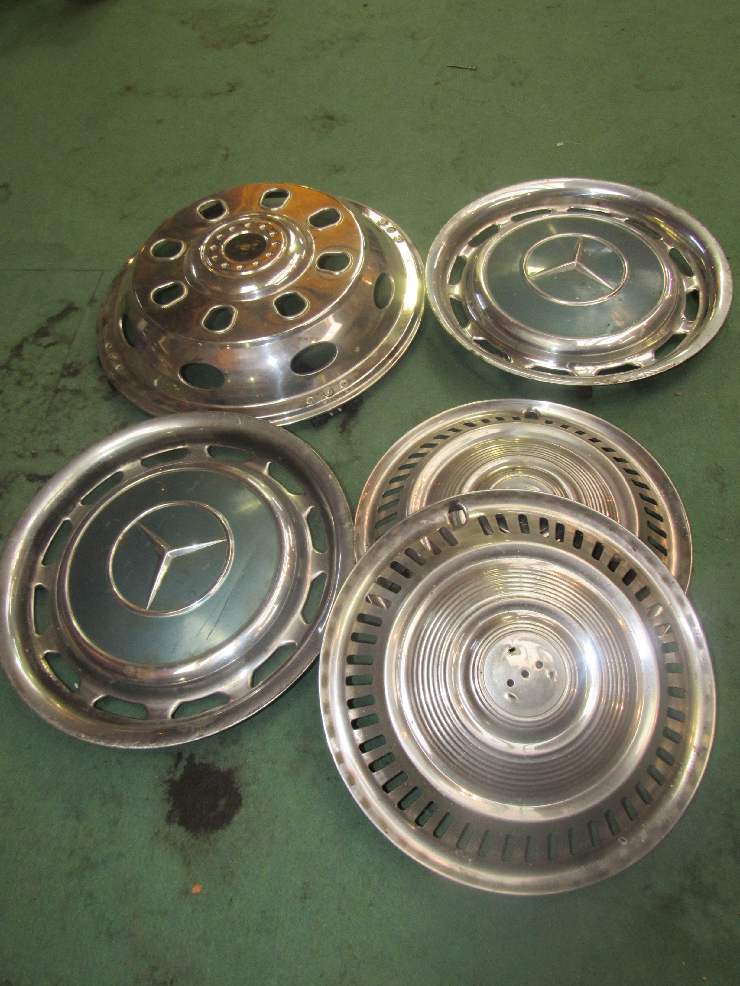 A box of mixed chromed hubcaps