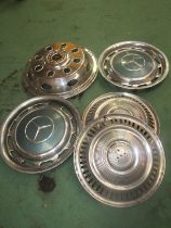 A box of mixed chromed hubcaps