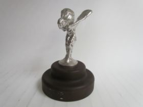 A chromed spirit of Ecstasy mounted on a plinth