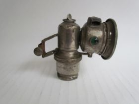A Lucas lamp, dented and split on the reservoir