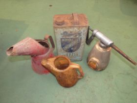 A Royal Snowdrift antifreeze can, two oil jugs and a Shell upper cylindar lubricator