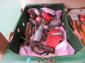 A box of oil cans and two brass grease guns
