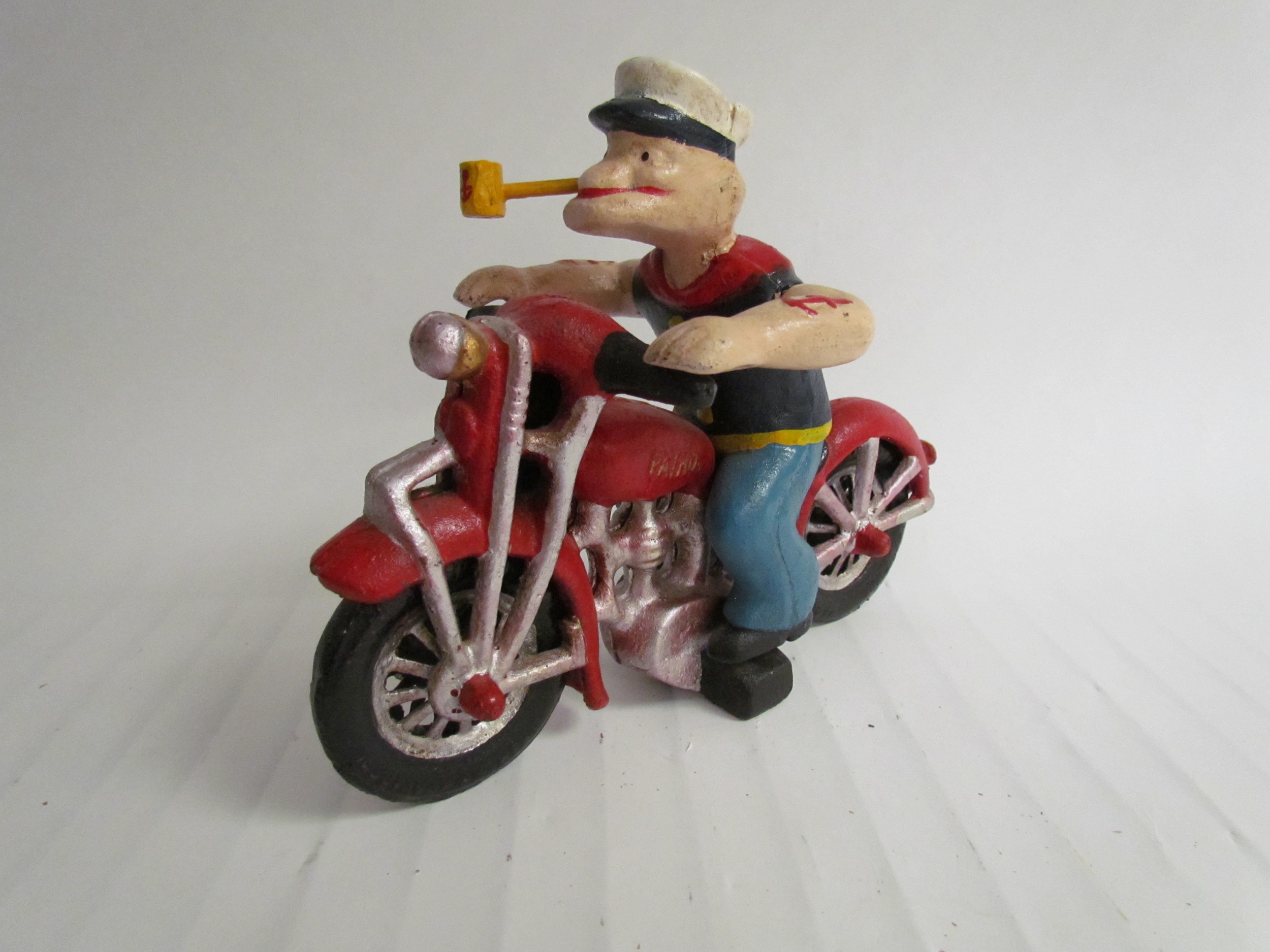 A cast reproduction Popeye riding a motorcycle figurine - Image 2 of 2
