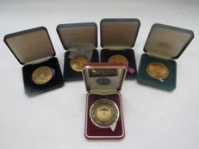 Three RAC 'Norwich Union' medallions, an RAC Rally of Great Britain 'York' medallion and a 1999
