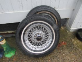 Two Jaguar E-Type wire spoke wheels with tyres, one has been re-chromed