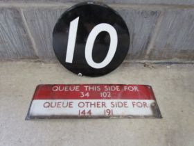 Two 1950's enamel bus signs 'Queue this side for 34,102 and Queue other side for 144,191' and a