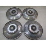 Four chromed Jaguar hubcaps