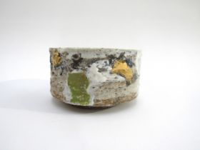 ROBIN WELCH (1936-2019) A studio pottery bowl, rough textured with painted splashes of green and