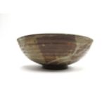 A Studio pottery bowl with brown and blue glazes, impressed G.N. seal, exhibition labels to base,