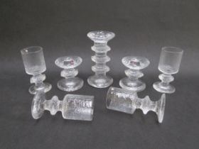 Three Iittala 'Festivo' candlesticks together with four Senaattori wine glasses, all designed by
