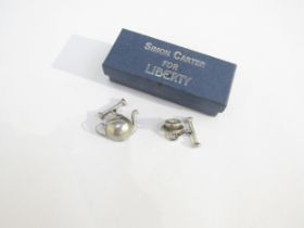 Simon Carter for Liberty: A boxed set of cufflinks modelled on a teapot and cup and saucer,