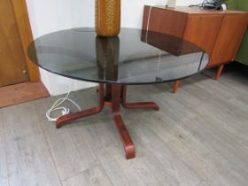 A Danish coffee table with bent ply base and smoked glass circular top. 90cm diameter x 50cm high