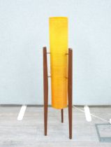 A c1970's Rocket floor amp with teak supports and spun fibre shade in orange. 94cm high