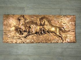 A mid century 'bronzed' painted wall plaque depicting three horses. Unmarked. 23cm x 58cm