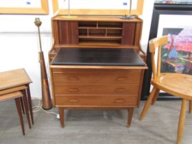 A 1960's Scandinavian teak secretaire, the tambour top gallery back opening to reveal sectional