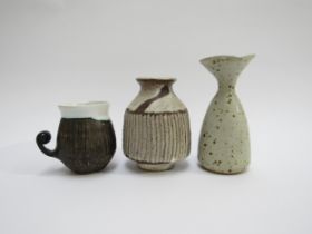 Studio Pottery - A 13cm high stoneware vase with flared rim, ash glaze with manganese spots, potters