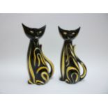 A pair of West German Pottery stylised cat vases in black with yellow stripes. 21cm high