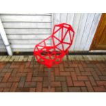 A Magis Chair One designed by Konstantin Grcic, red geometric seat on metal legs