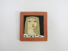 CHRISTY KEENEY (b.1958) A studio pottery wall plaque of a girl, signed verso. 14cm x 13cm