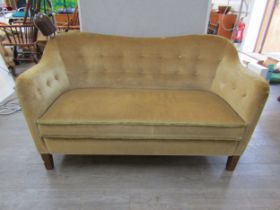 A 1940's Danish twin seater sofa with curved shaped back in original olive green upholstery. 137cm x